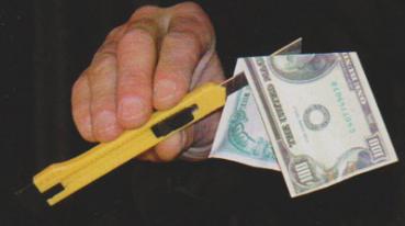 Cutter knife through banknote 